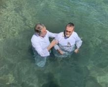 Jerry Lutz, executive secretary for the Chesapeake Conference, baptizes a seminar attendee during a mission trip to Roatan, Honduras.